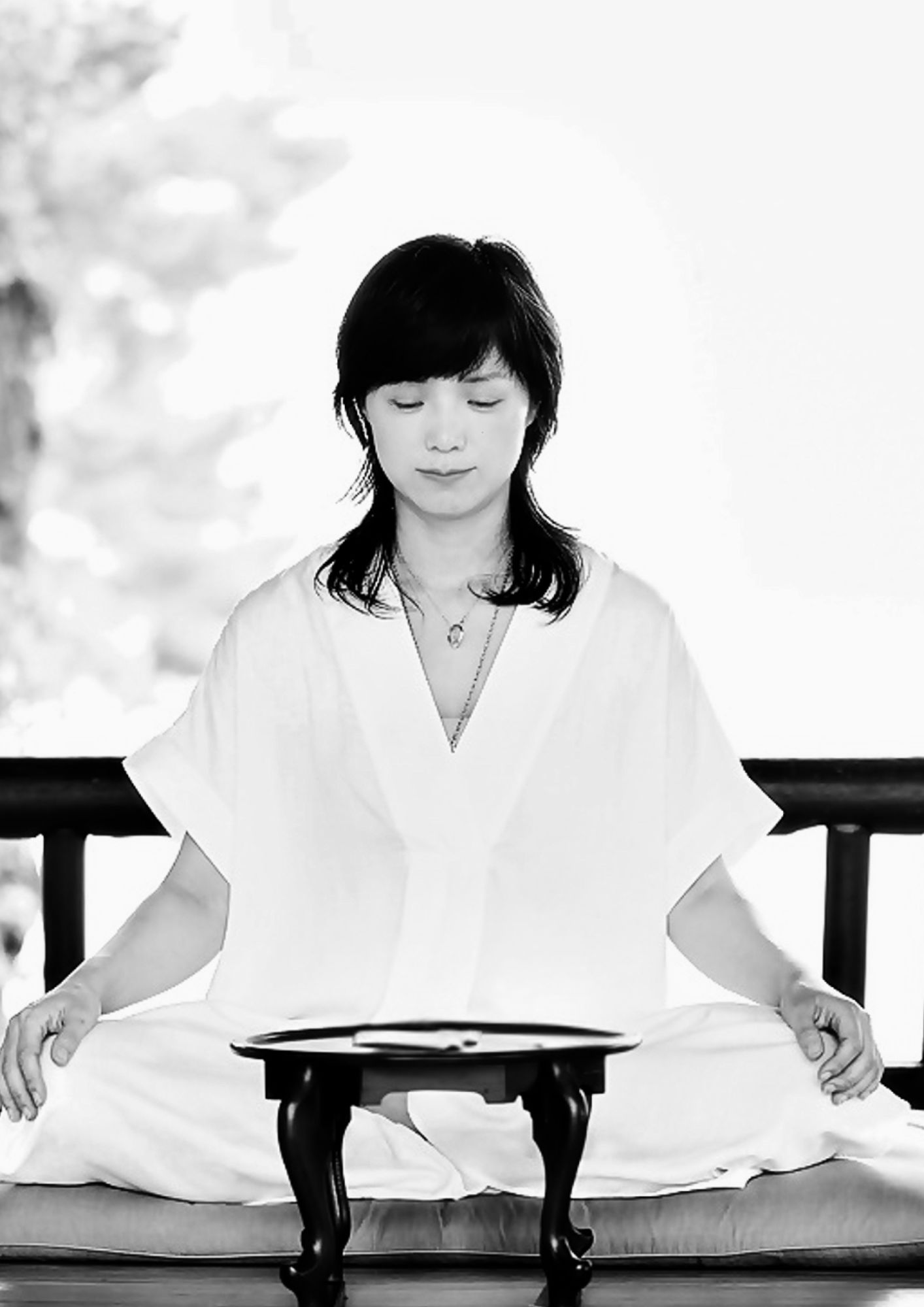 Portrait of ritual media artist Soojin Pray seated in meditation