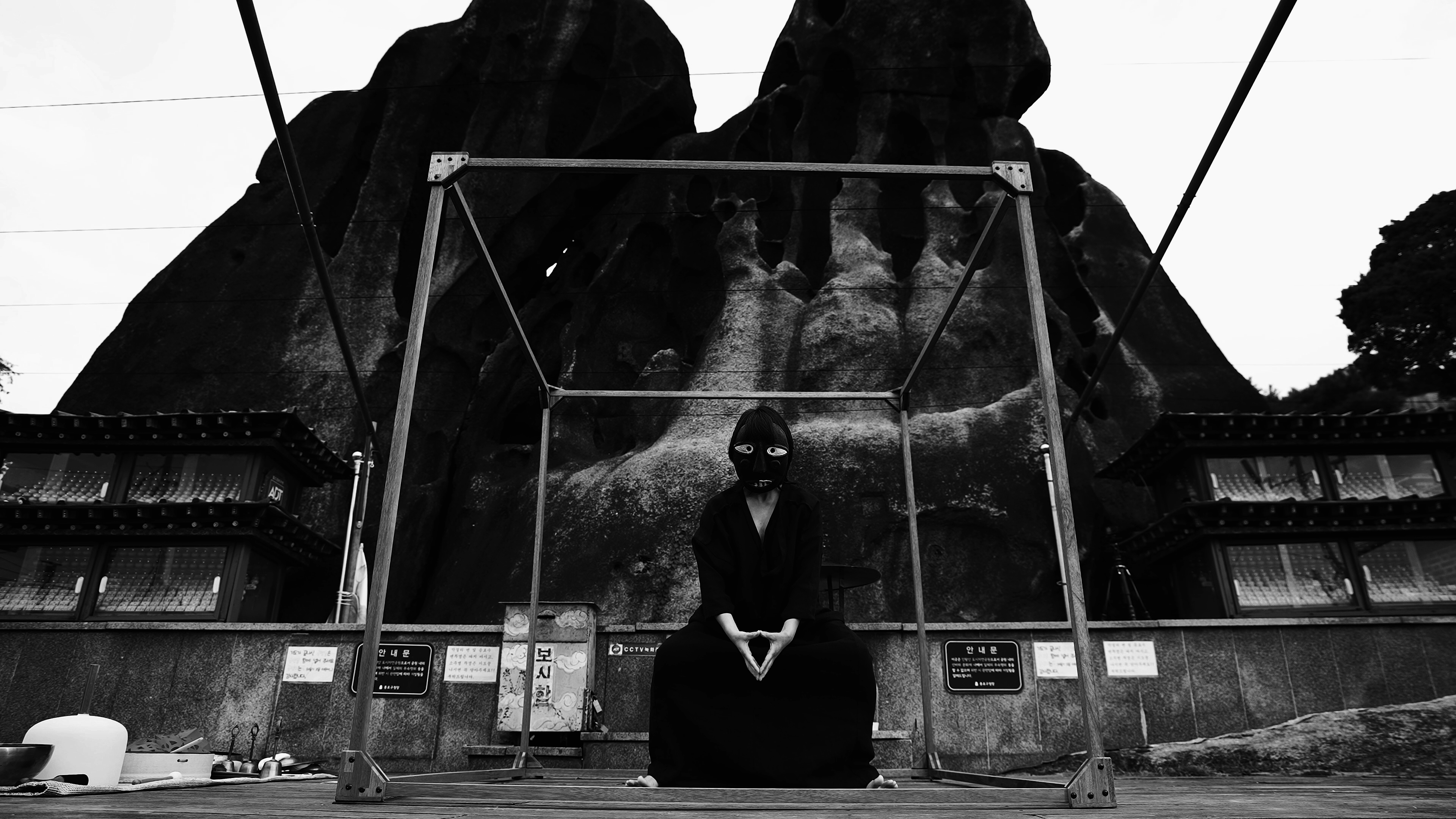 The masked artist performing at Seonbawi Rock before dawn