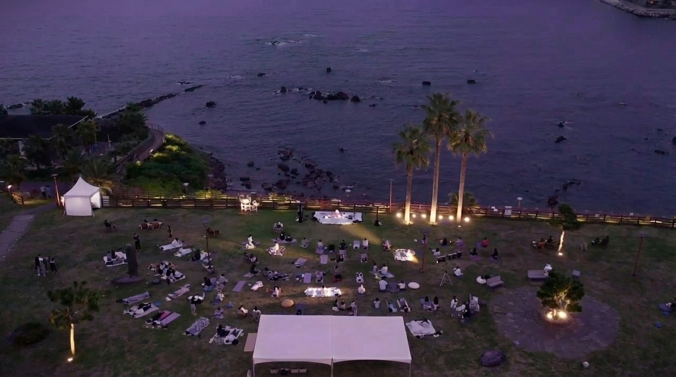 Dusk performance at Jaguri Park with the audience reclining across the coastal field